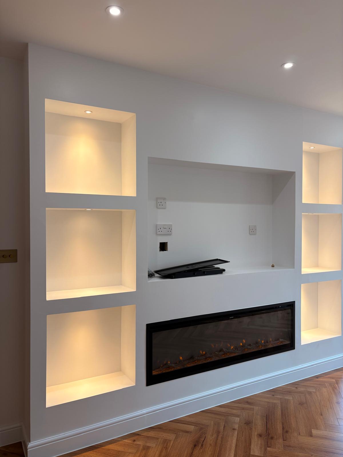 Built-in media wall with display alcoves and inset electric fire